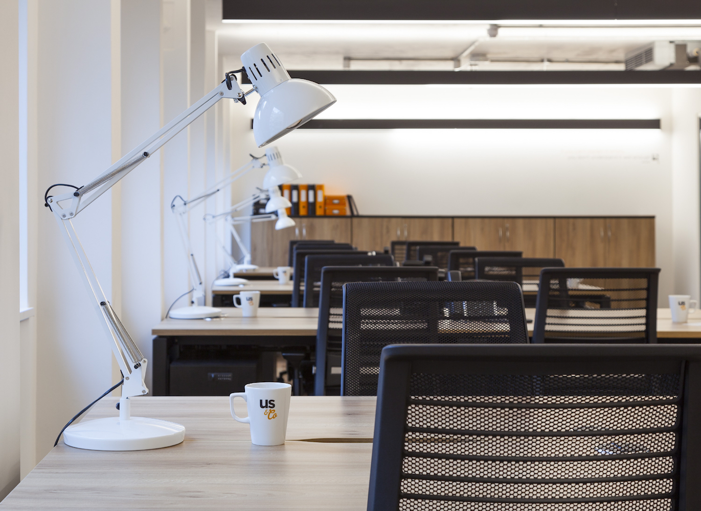 Us&Co's private co-working space with office furniture, office chairs, dedicated desks, cabinets & desk lamps.