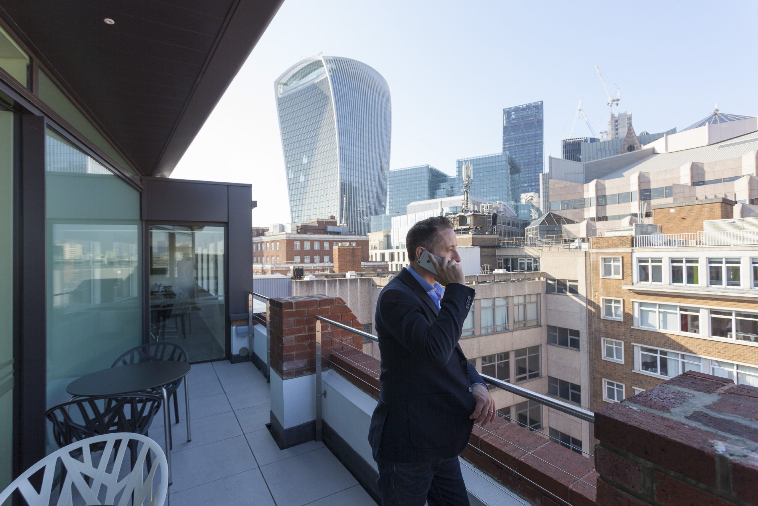 Businessman on a balcony in London